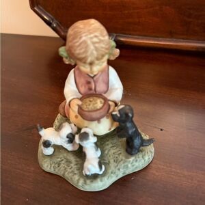 Hummel figurine 'Bowlful of Love' Figurine showing a girl feeding 3 puppies